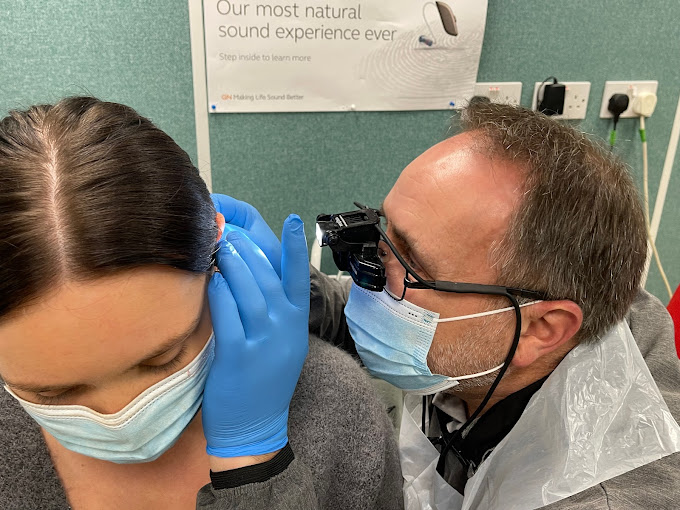 Nick Wootton, audiologist at Prestige Hearing, wearing clinic uniform