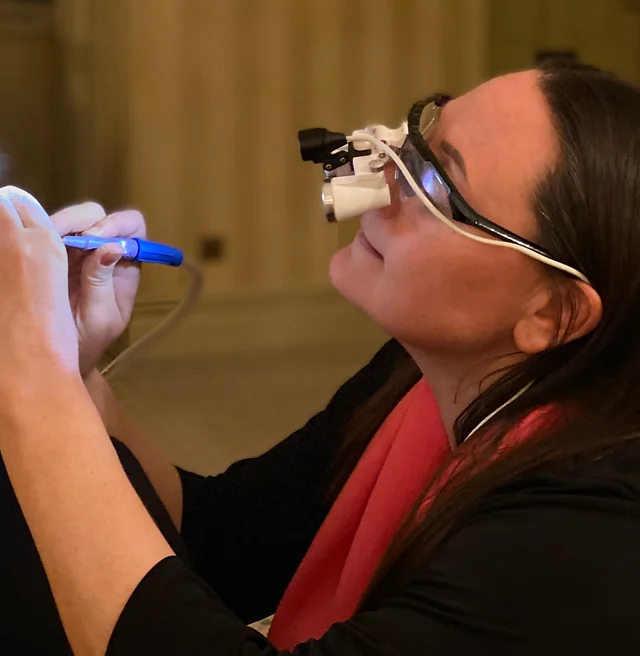 Louise Moss, principal audiologist, carrying out an ear examination at the Bridgend clinic